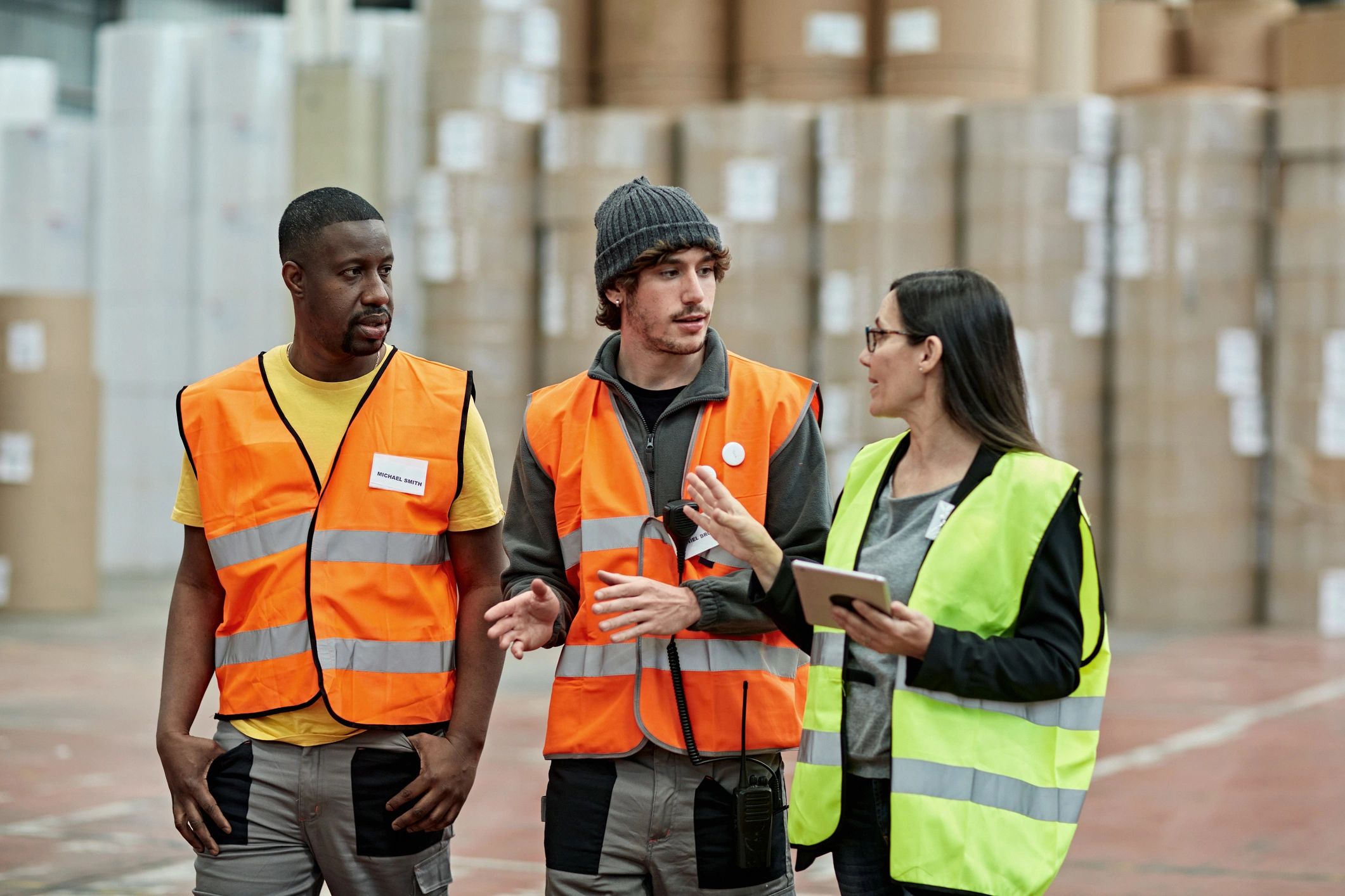 Supervisor coordinating with warehouse workers