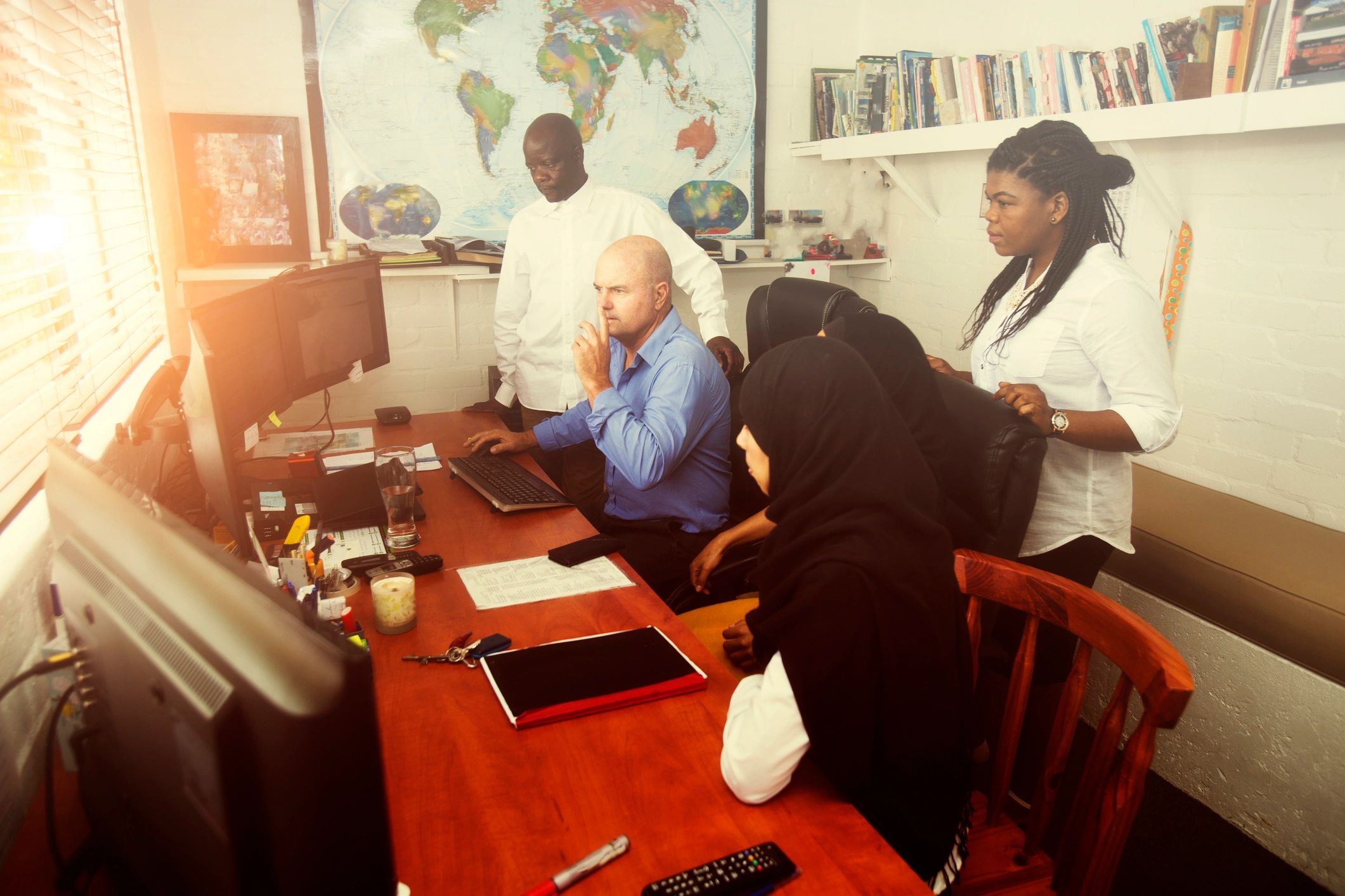Dispatch team coordinating a shipment at a computer